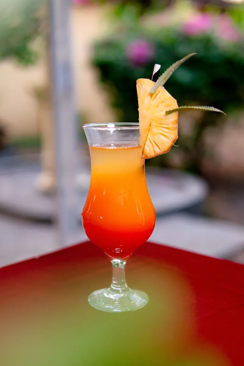 Tropical sunrise cocktail with pineapple garnish